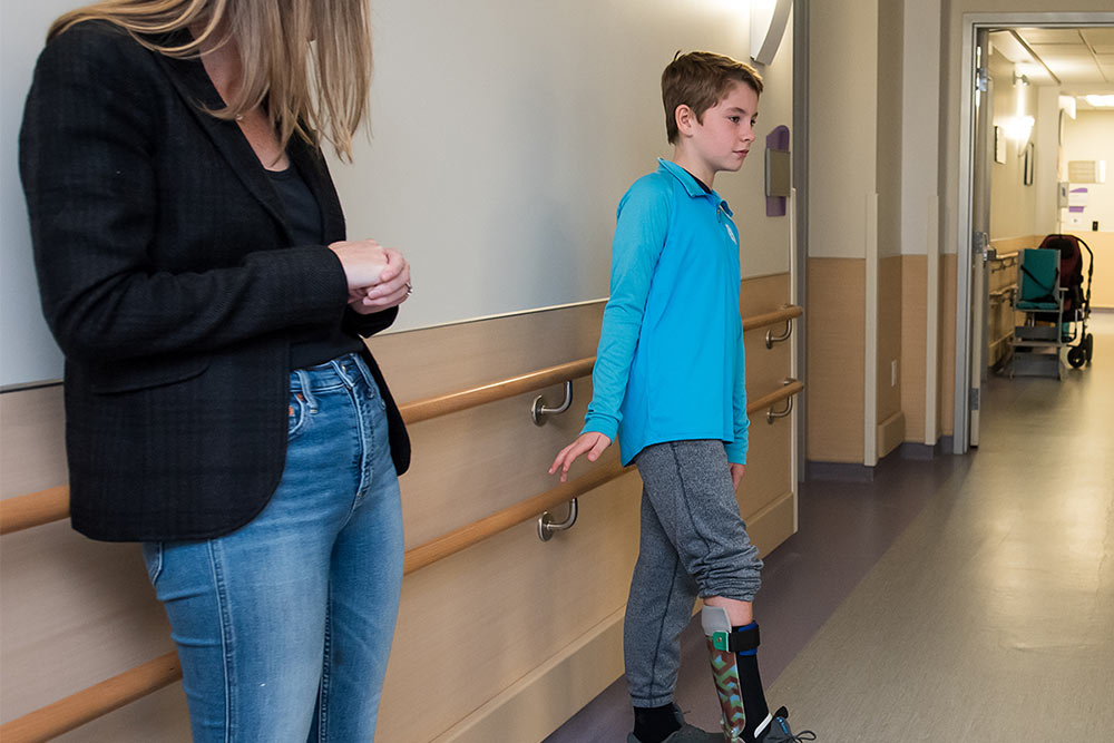 young boy standing in SSCY Centre with adult